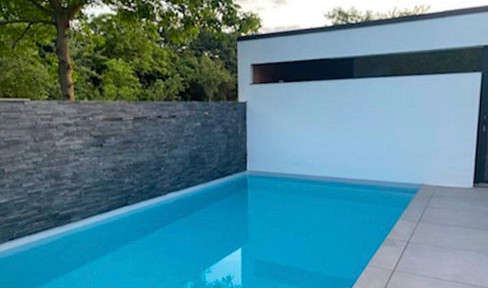 Unique single-family home with a pool, located on the edge of a field.