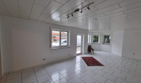 Ground floor apartment with two rooms, featuring a large living area, an open-plan kitchen, and a garage.