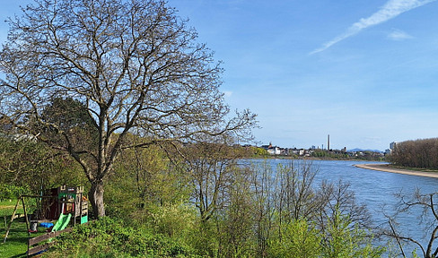 Unique ground-floor apartment with unobstructed views of the Rhine, private garden, new construction, and no commission fees.