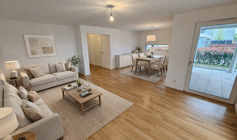 Live like you're in your own house – a modern garden apartment on the Altrhein river with a terrace and underground parking.