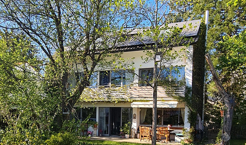 Spacious single-family home with a large garden and mature trees.