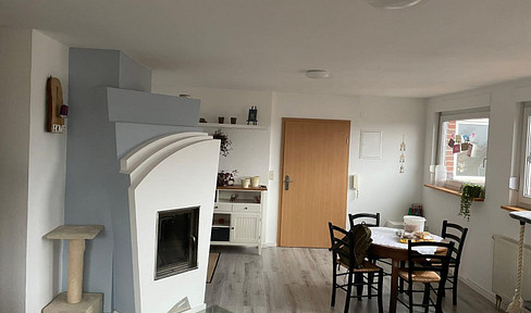 Bright attic apartment with a fireplace.