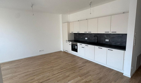 Directly on the waterfront | New construction + never occupied | ~67 sqm, 2-room apartment | Balcony, elevator, fitted kitchen, parking space.