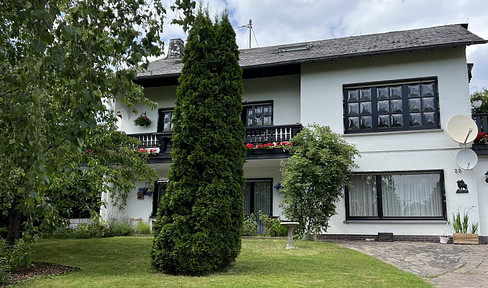 House in the Greenery.
Alternatively:
House surrounded by greenery.
Or:
House in a green setting.