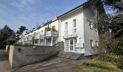 Stylish split-level loft apartment with a garden, located in a renovated factory building, and includes a parking space in an underground garage.