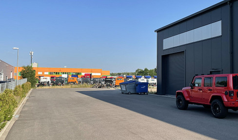 Modern logistics hall / assembly hall with a small office area and restrooms.