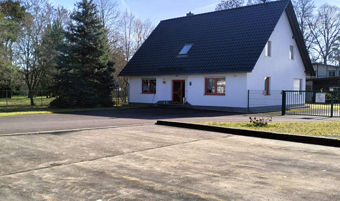 Detached single-family house with spacious outbuildings and garden shed.