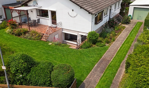 Detached house with a spacious garden, swimming pool, and garage.