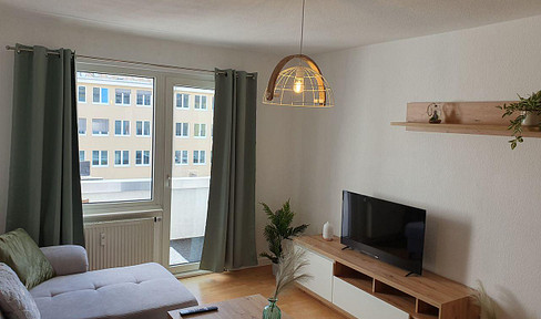 Fully furnished apartment with a small balcony.