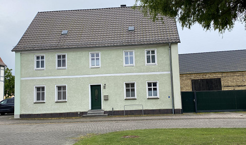 Two-generation house with outbuildings and a large garden.
