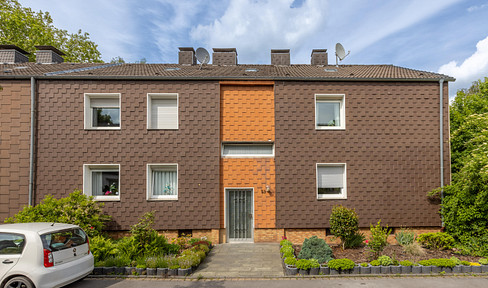 Bright, well-maintained apartment with a balcony, modern furnishings, and a view of greenery.