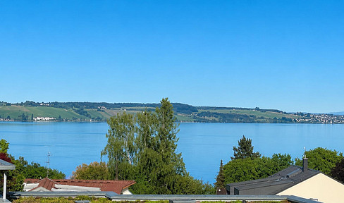 Sun-drenched balcony with views of the lake and the Alps.