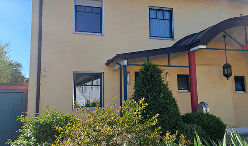 Detached house with an attached apartment and conservatory.