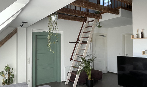 Exclusive maisonette apartment with a mezzanine level and garden, located in a stylish urban villa.