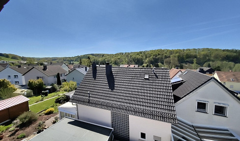 Quiet 2.5-room apartment with a balcony and distant views.