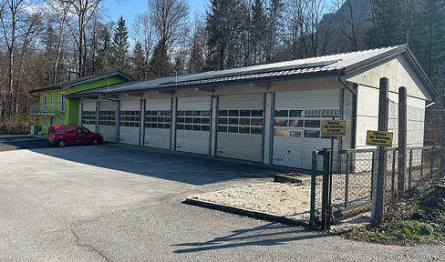 Office building with warehouse and ample parking spaces.