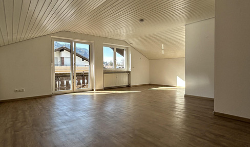 Bright attic apartment with mountain views, featuring two balconies, located in a quiet residential area.