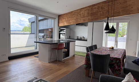 Exclusive loft apartment with a designer kitchen, air conditioning, 2 balconies, and a garage – 110 square meters of living space.