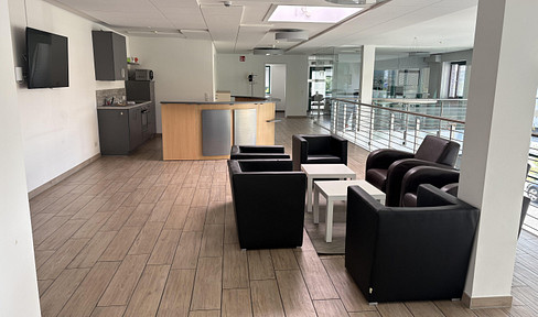 Modern office space available for rent, surrounded by classic buildings.