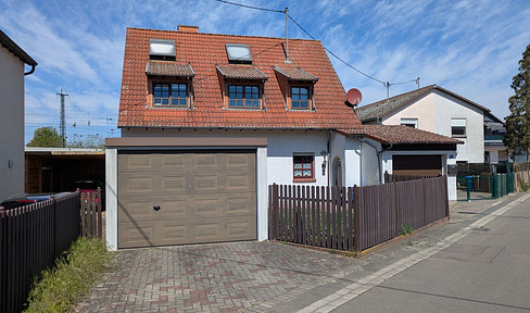 Well-maintained two-family house with a large garden, garage, and a variety of potential uses.