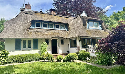 Dreamlike thatched-roof house near the Baltic Sea.