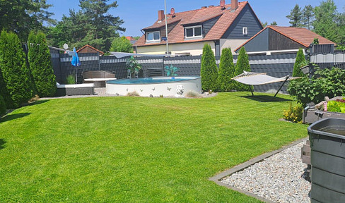 Modernized semi-detached house with a pool, battery storage for solar power, and potential for further development.