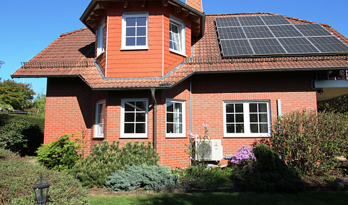 Attractive single-family home featuring a heat pump, solar panel system with storage, and a beautiful garden.