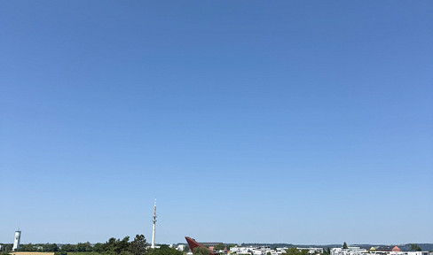 Exclusive penthouse apartment with a rooftop terrace and views of the Petrisberg tower.