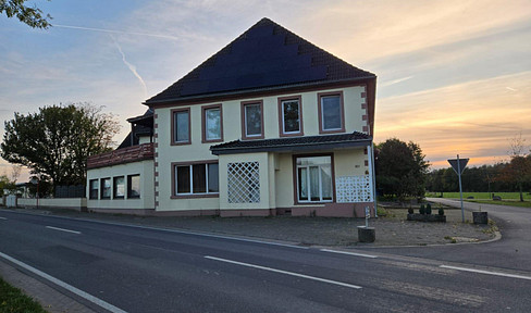 Two-family house with a barn and a large private plot of land.