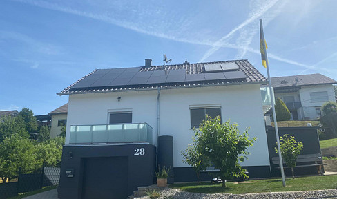 Modernized single-family home with a photovoltaic system, battery storage, and a large plot of land.
