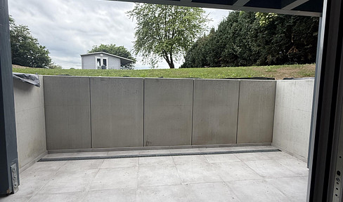 New construction! Stylish 2-room apartment in Grömitz, featuring a Danish design kitchen, a 14m² terrace, and views of the fields.