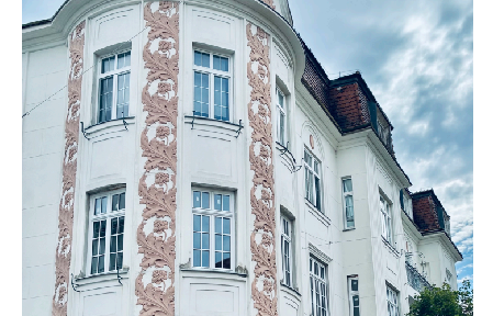Beautifully renovated apartment in a historic building, featuring a large, sunny balcony.