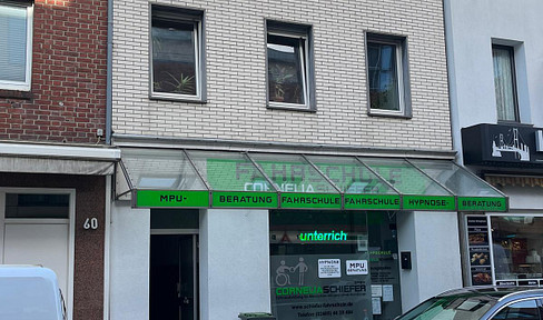 Multi-family house with a commercial space, located in a central area.