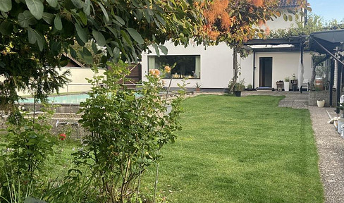 Dreamlike two-family house with a garden, forest views, a pool, sauna, and rental income.