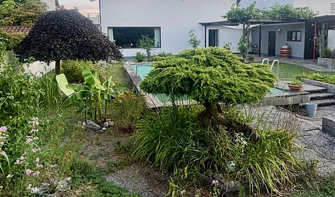 Dreamlike, detached two-family house with a view of the forest, featuring a pool, sauna, and a prime location.