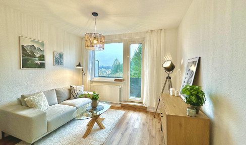 Completely renovated 3-room apartment with a balcony, fitted kitchen, and a view of greenery, located in Bremen-Woltmershausen.