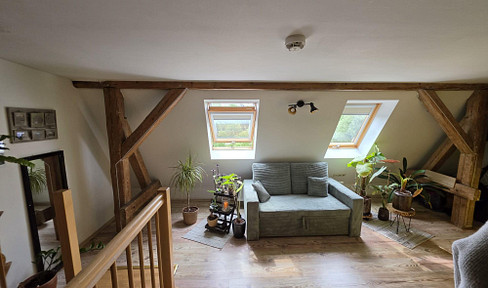 Two-story apartment with a balcony overlooking the courtyard.