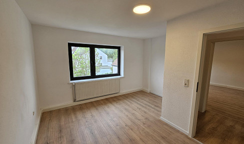 Investment opportunity: Fully let multi-family house (7.1% return), comprising 7 apartments and 4 parking spaces, with potential for further development.