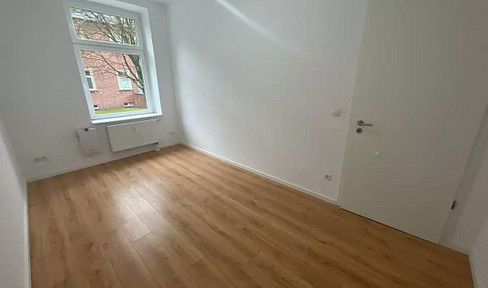 Apartment on a high floor with a spacious living/kitchen area and a balcony.