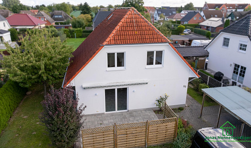 Detached house with a carport and garden.