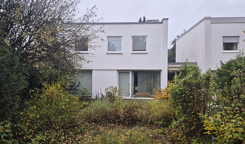 A timeless Bauhaus classic, nestled in a green setting.