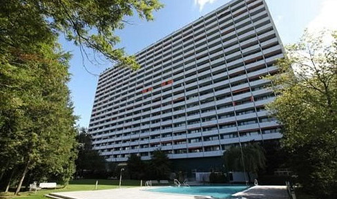 Furnished apartment in the southern part of Munich, with a swimming pool, green space, and distant views.