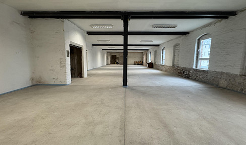 Open commercial space with a loft character and an industrial aesthetic.