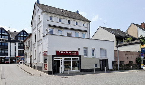 Multi-family building with commercial space and vacant land in Andernach, a prime location for the hospitality industry.