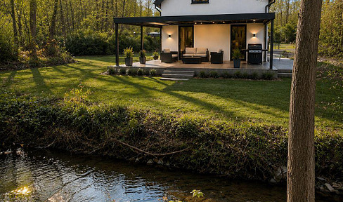 A house by the stream in the center of Odenthal, completely renovated with a heat pump, solar panels, air conditioning, and an electric vehicle charging station.
