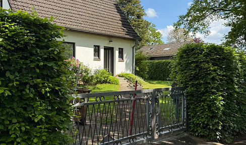 House with heart, located on the edge of a field.