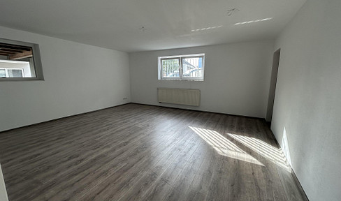 Bright basement apartment with fitted kitchen and parking space.
