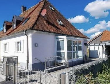 Charming semi-detached house with a garden landscape.