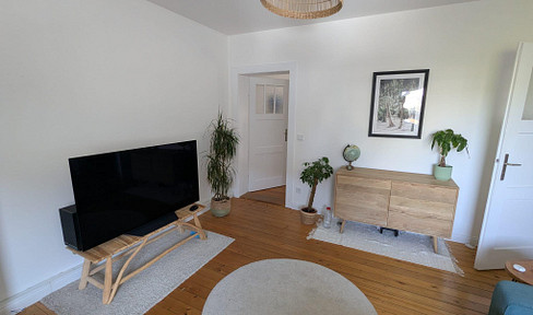 Charming 3-room apartment with balcony and real wood flooring.