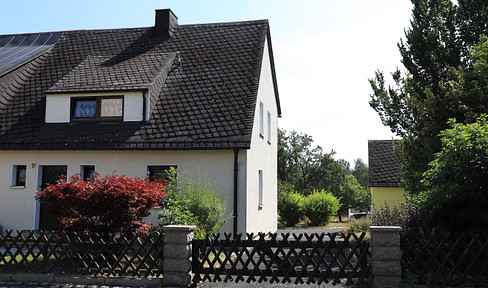 Semi-detached house with a garden, garage, workshop extension, patio, courtyard, and driveway.